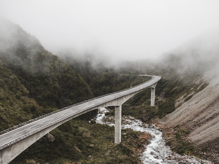 A person standing alone on a bridge, symbolizing the process of ending a relationship and moving forward.